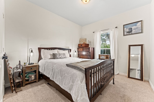 carpeted bedroom featuring vaulted ceiling and baseboards