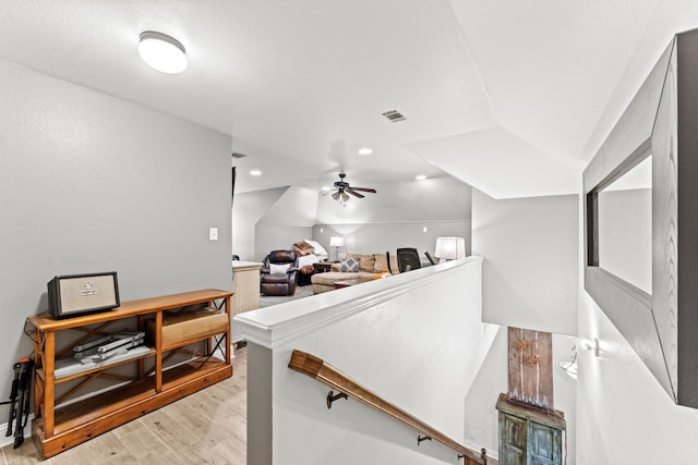 interior space with visible vents, an upstairs landing, light wood-style flooring, and recessed lighting