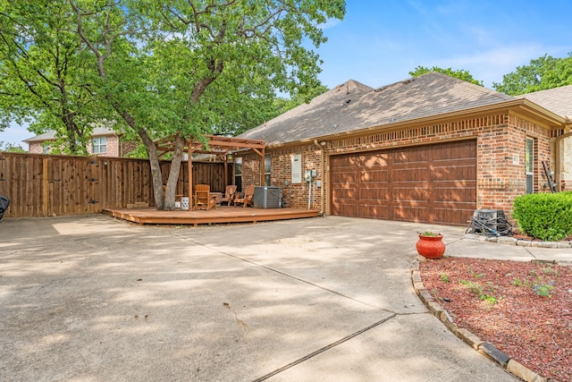 view of front of house featuring a pergola, roof with shingles, fence, and brick siding