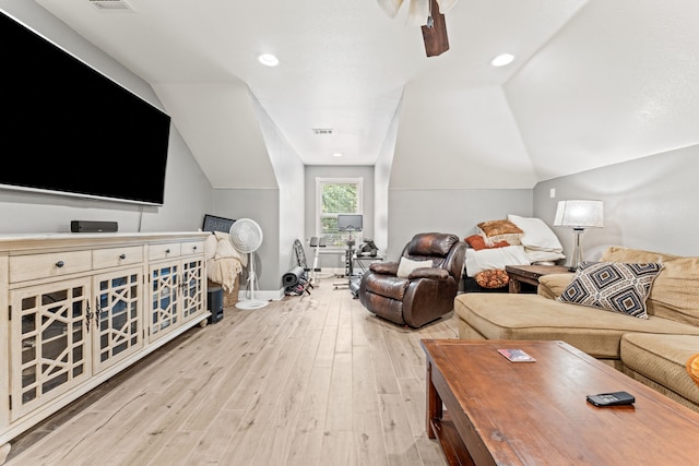living room with wood finished floors, vaulted ceiling, baseboards, visible vents, and a ceiling fan