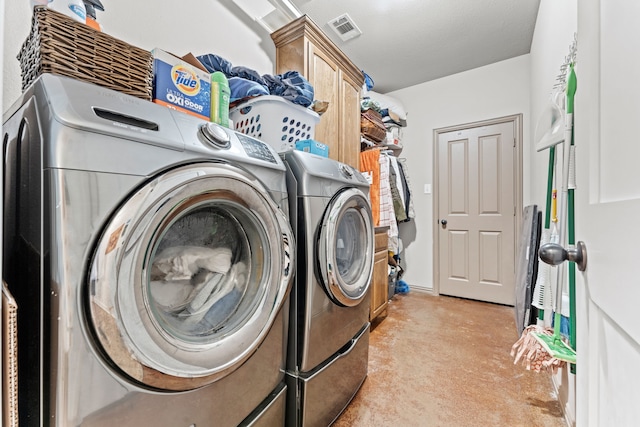 laundry area with washing machine and dryer, visible vents, cabinet space, and light colored carpet