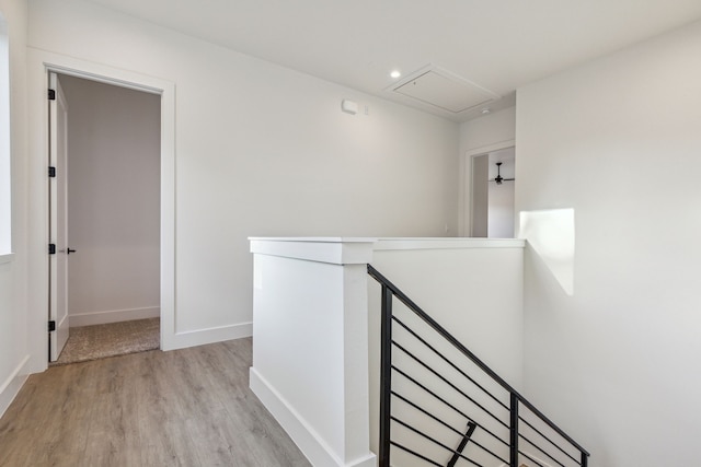 hall with attic access, recessed lighting, an upstairs landing, light wood-style flooring, and baseboards