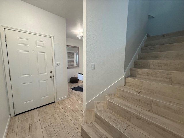 interior space featuring wood tiled floor and baseboards
