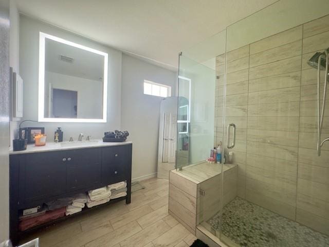 bathroom with vanity and a stall shower