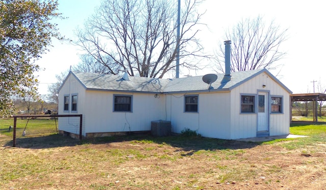286 N Fm 1851, Voca, TX 76887 - rear view of house with central AC, a shingled roof, and a yard