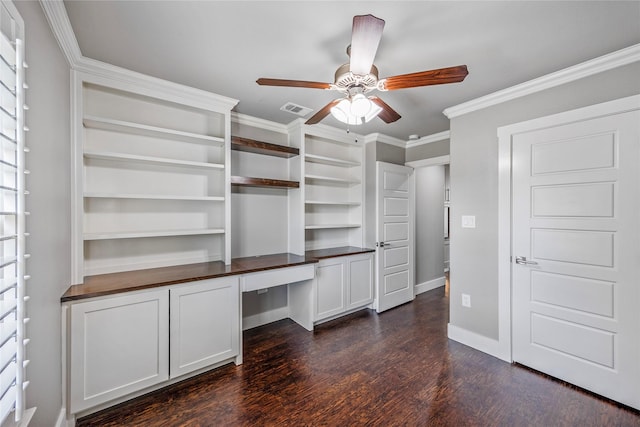 walk in closet with ceiling fan, visible vents, dark wood finished floors, and built in study area