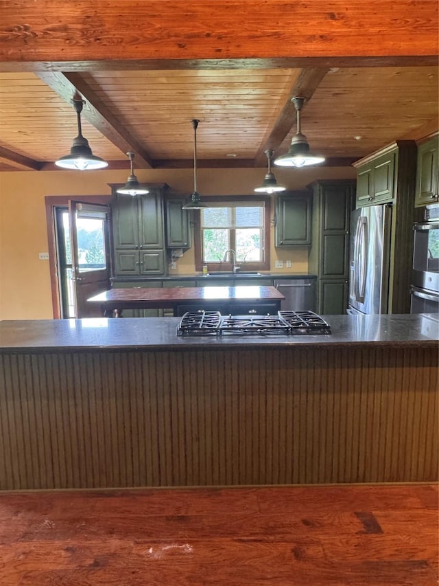 kitchen with dark countertops, appliances with stainless steel finishes, wood ceiling, and wood finished floors