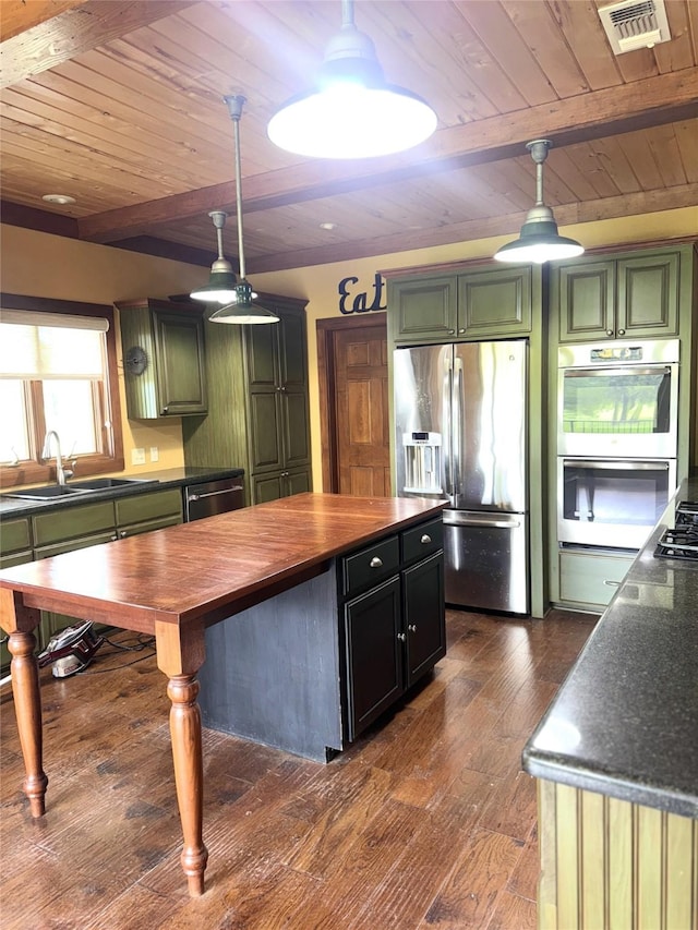 kitchen featuring wood ceiling, wooden counters, a sink, green cabinetry, and stainless steel appliances
