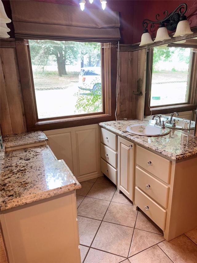 bathroom with plenty of natural light, tile patterned flooring, and vanity