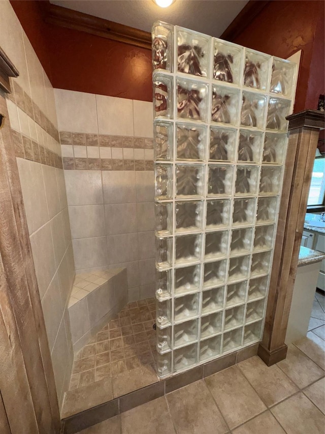 full bath featuring a walk in shower and tile patterned flooring