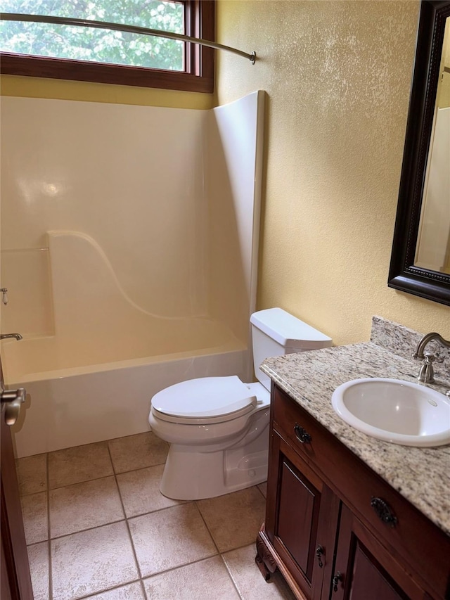 bathroom featuring vanity, tile patterned flooring, bathtub / shower combination, and toilet