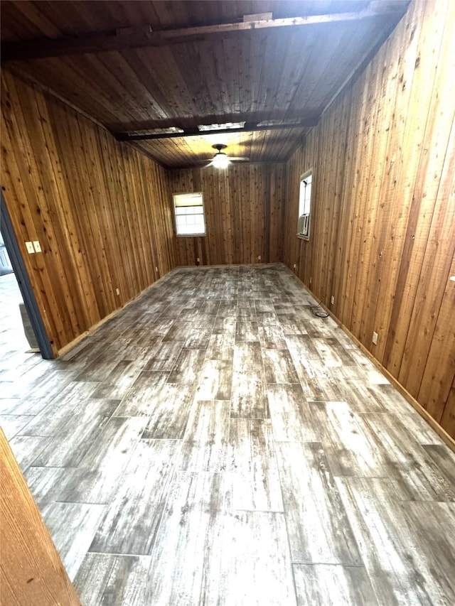 basement featuring wood walls, wood ceiling, a wealth of natural light, and hardwood / wood-style flooring