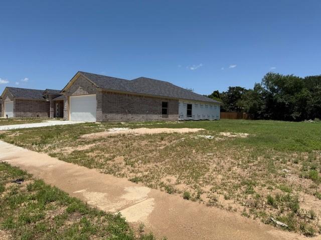 10185 Budtime Ln, Dallas, TX 75217 - property under construction featuring driveway and an attached garage