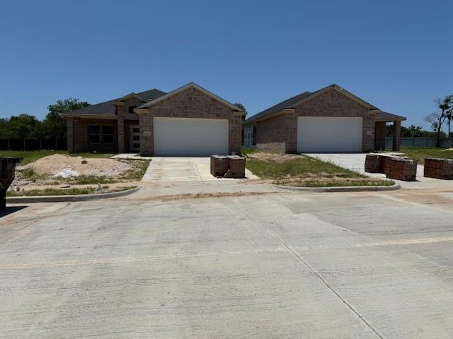 10185 Budtime Ln, Dallas, TX 75217 - ranch-style house with brick siding, a garage, concrete driveway, and a front yard