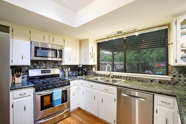 2403 Leslie St, Denton, TX 76205 - kitchen featuring appliances with stainless steel finishes, a sink, dark countertops, and decorative backsplash