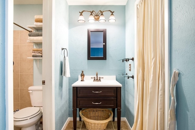 2403 Leslie St, Denton, TX 76205 - bathroom with tile patterned flooring, toilet, and vanity