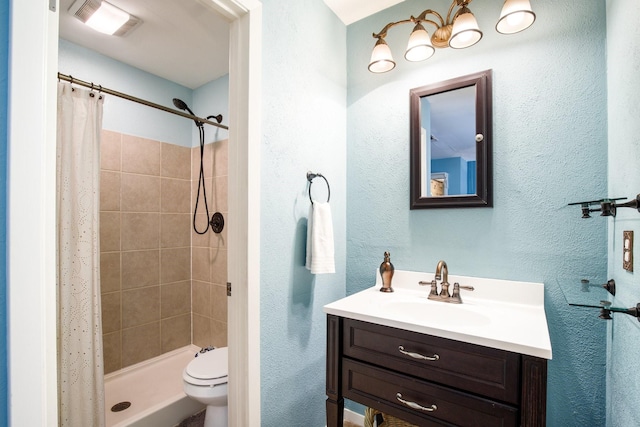 2403 Leslie St, Denton, TX 76205 - bathroom featuring a shower stall, toilet, vanity, and a textured wall