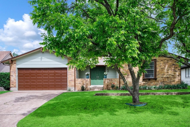 2403 Leslie St, Denton, TX 76205 - view of front facade with brick siding, a garage, concrete driveway, and a front yard