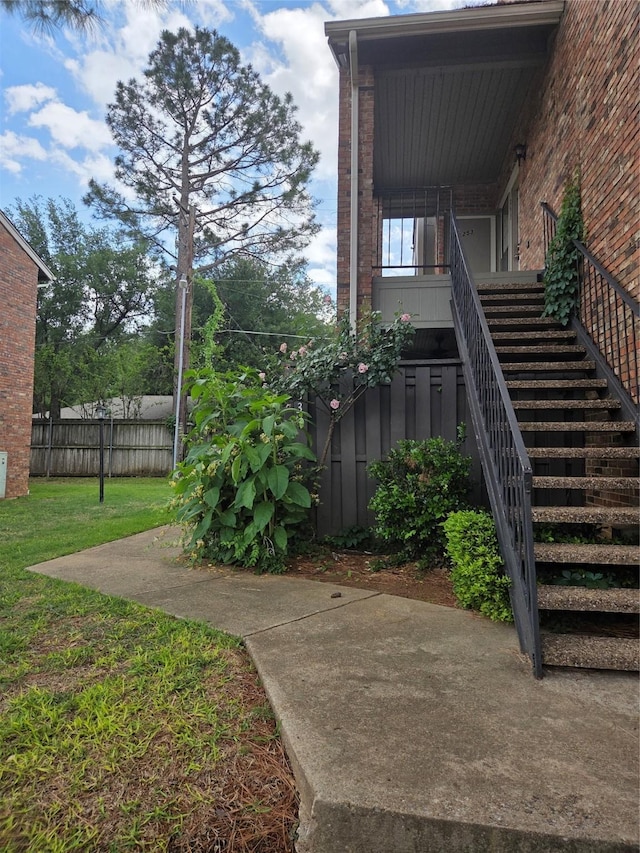 view of yard featuring fence and stairway