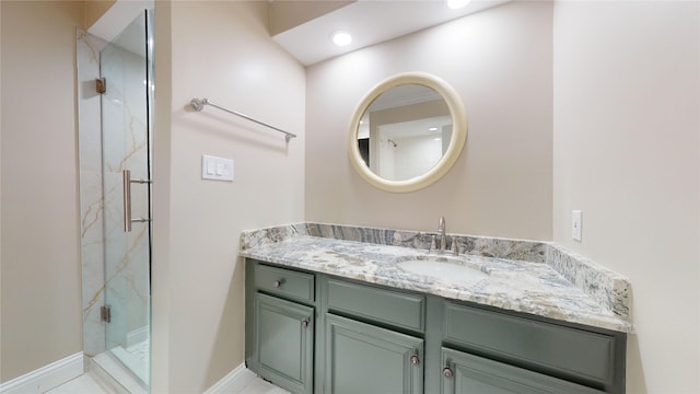 bathroom with a marble finish shower and vanity