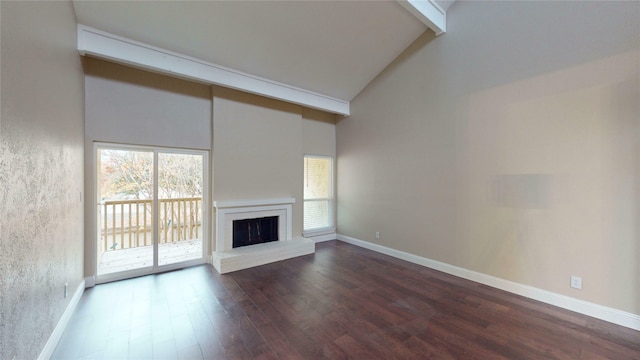 unfurnished living room with a wealth of natural light, high vaulted ceiling, dark wood finished floors, and a brick fireplace