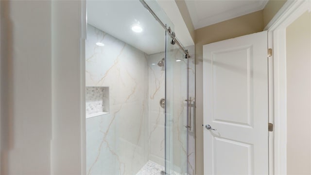 full bathroom with a marble finish shower and crown molding