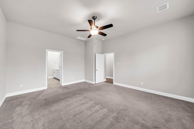 unfurnished bedroom featuring visible vents, ensuite bath, carpet floors, and baseboards