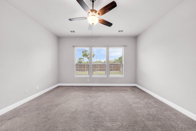 unfurnished room featuring carpet, visible vents, a ceiling fan, and baseboards