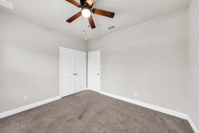 interior space featuring a closet, a ceiling fan, visible vents, baseboards, and carpet floors