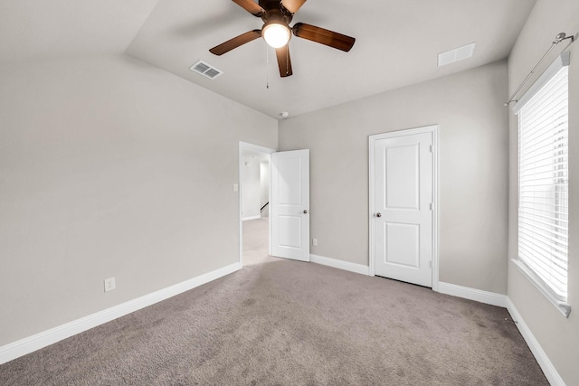 unfurnished bedroom with visible vents, carpet, and baseboards