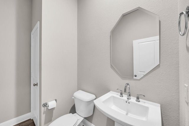 half bath with toilet and a sink
