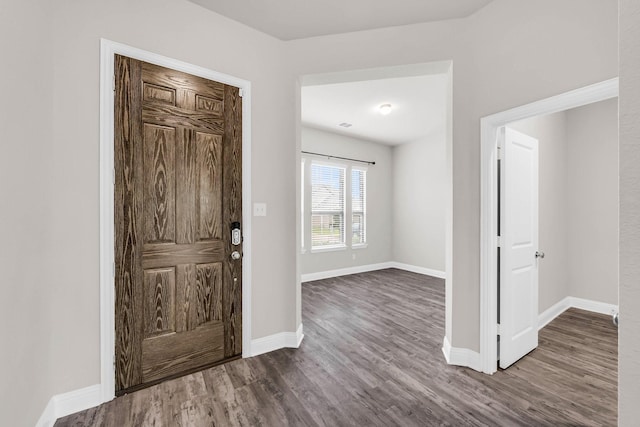 entrance foyer featuring baseboards and dark wood-type flooring