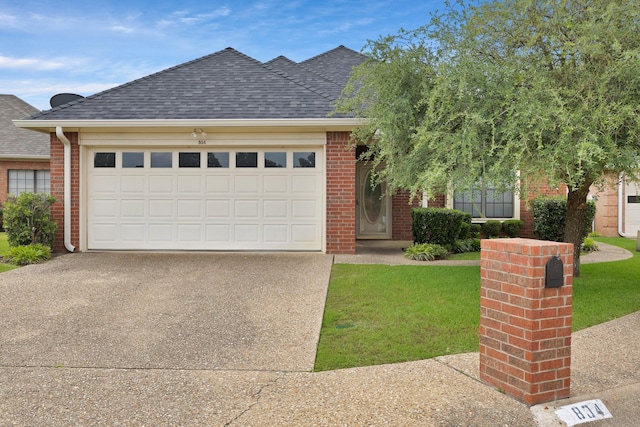 view of front of house featuring a front lawn, a garage, brick siding, driveway, and roof with shingles