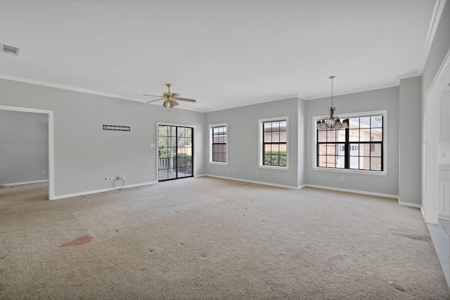 empty room featuring ceiling fan with notable chandelier, baseboards, ornamental molding, and a wealth of natural light
