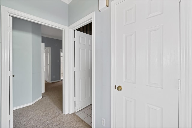 hallway with carpet and baseboards