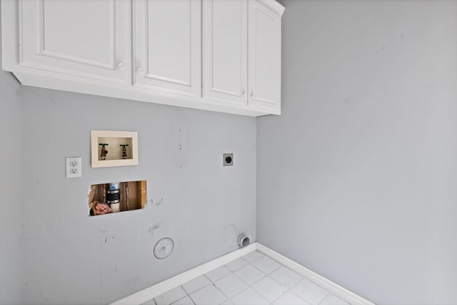 washroom featuring hookup for a washing machine, electric dryer hookup, cabinet space, hookup for a gas dryer, and baseboards