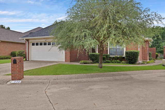 obstructed view of property with concrete driveway, a shingled roof, brick siding, a front lawn, and a garage