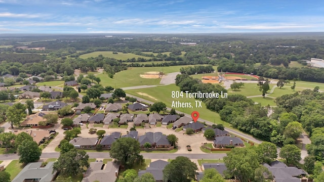drone / aerial view featuring golf course view and a residential view