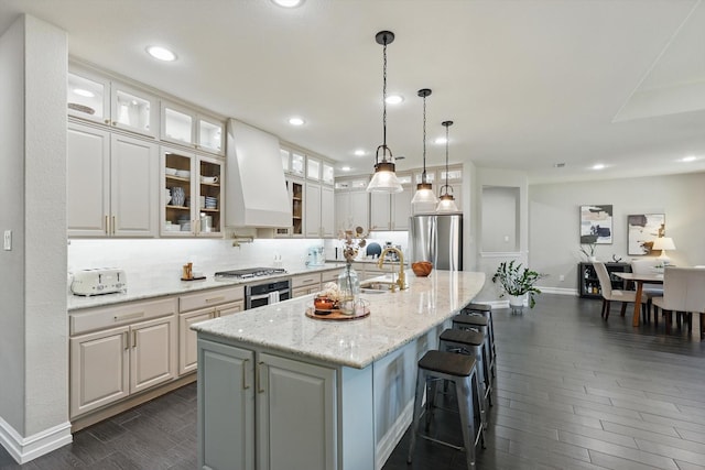 1146 Berrydale Dr, Northlake, TX 76226 - kitchen featuring stainless steel appliances, custom range hood, dark wood-style floors, white cabinets, and an island with sink