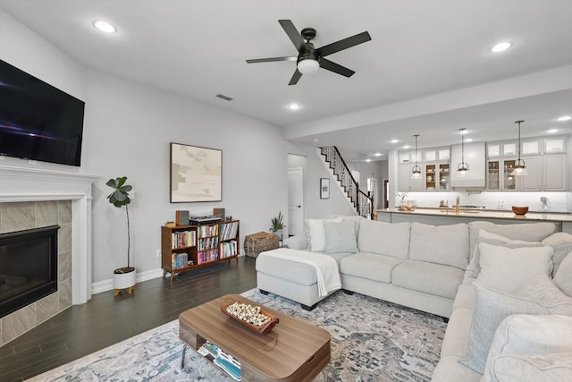 1146 Berrydale Dr, Northlake, TX 76226 - living area featuring recessed lighting, a ceiling fan, dark wood-type flooring, stairway, and a tile fireplace