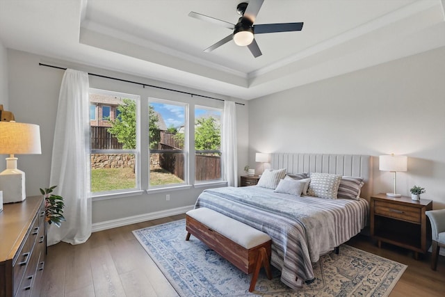 1146 Berrydale Dr, Northlake, TX 76226 - bedroom featuring a raised ceiling, wood finished floors, a ceiling fan, and ornamental molding