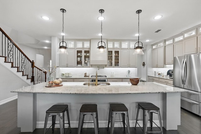 1146 Berrydale Dr, Northlake, TX 76226 - kitchen with stainless steel appliances, a large island, decorative backsplash, white cabinetry, and a kitchen breakfast bar