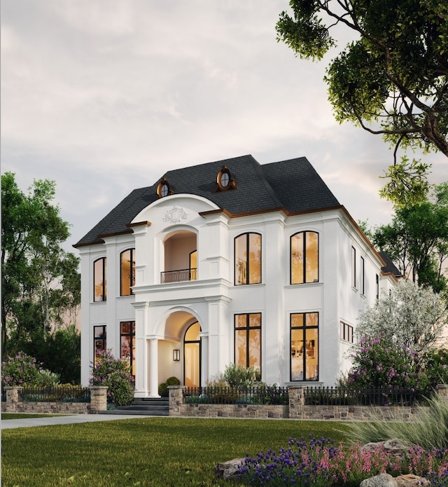 view of front of property with a front lawn, a shingled roof, stucco siding, and a balcony