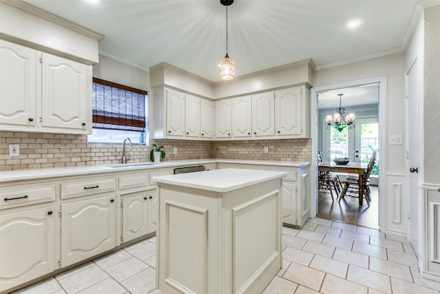 kitchen featuring a sink, light tile patterned floors, a chandelier, backsplash, and light countertops