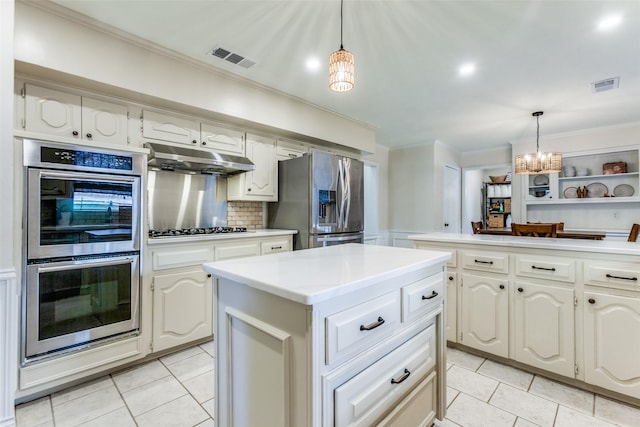 kitchen featuring stainless steel appliances, light tile patterned floors, ornamental molding, a chandelier, and a center island
