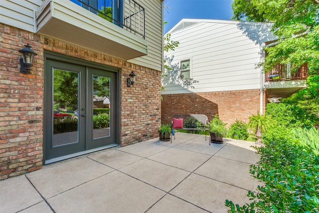 view of patio featuring french doors and a balcony