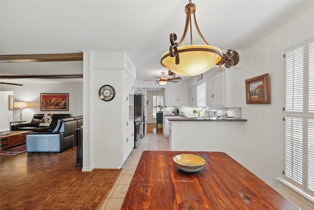 dining space with plenty of natural light, light tile patterned flooring, and ceiling fan
