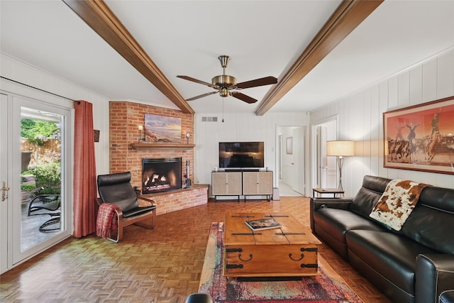 living room with visible vents, ceiling fan, a fireplace, and beamed ceiling