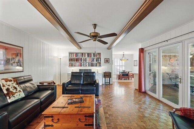 living area featuring a ceiling fan and beam ceiling