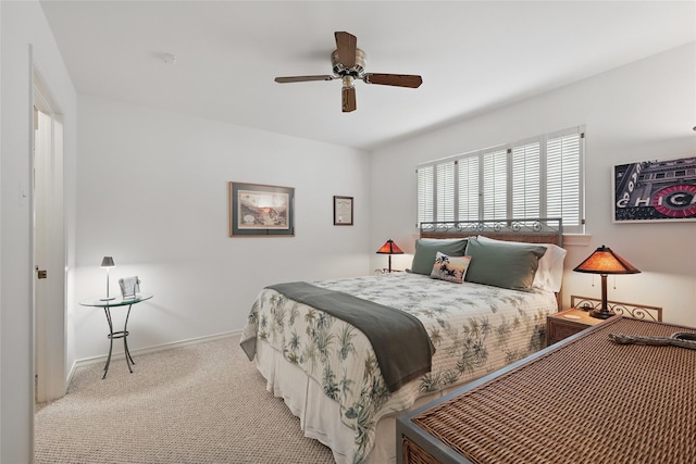 carpeted bedroom featuring baseboards and ceiling fan